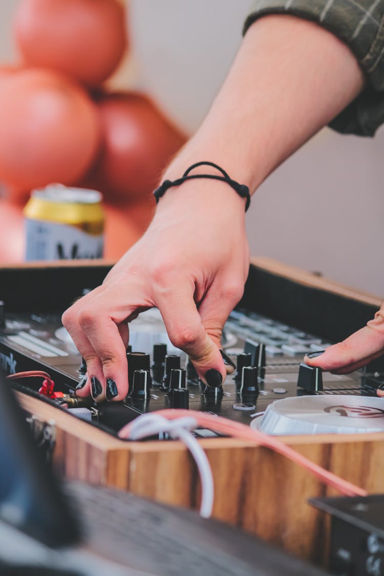 Woman Hand On DJ Mixer