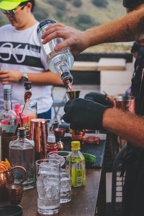 Barman Hands Pouring Drink