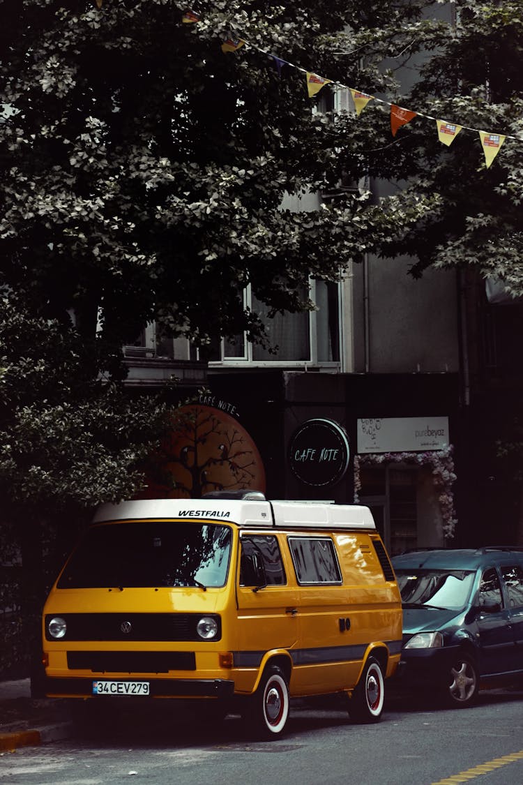 Photograph Of A White And Yellow Van