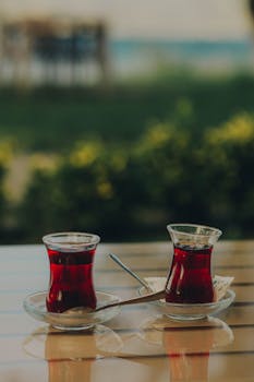 Two glasses of Turkish tea on an outdoor table in Sapanca, Turkey, capturing a serene and traditional moment.