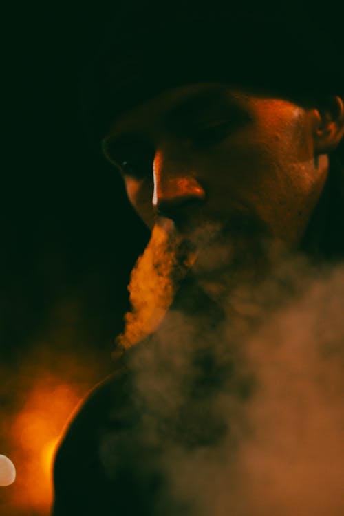 Smoke over Man Face in Darkness