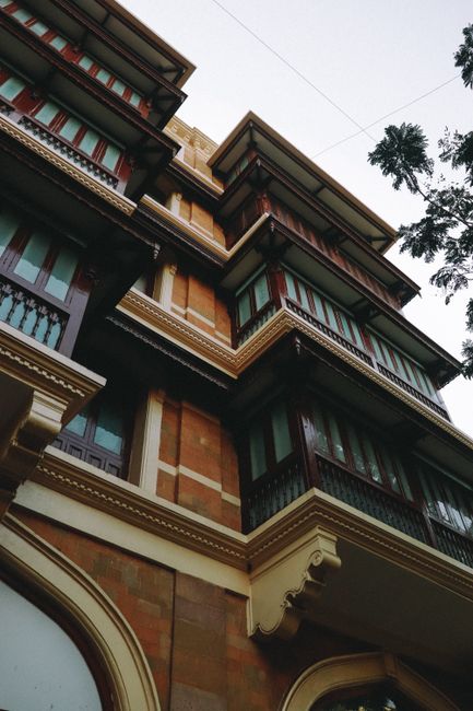 Low angle view of a historic building facade with wooden balconies, showcasing architectural elegance.