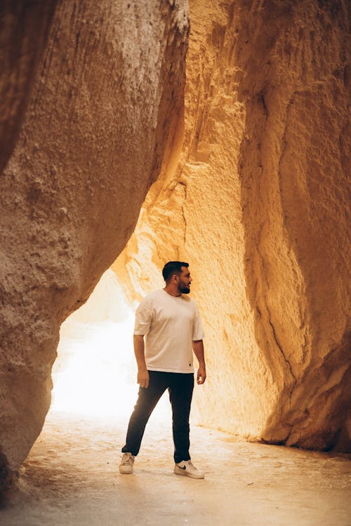 Man Standing in Cave