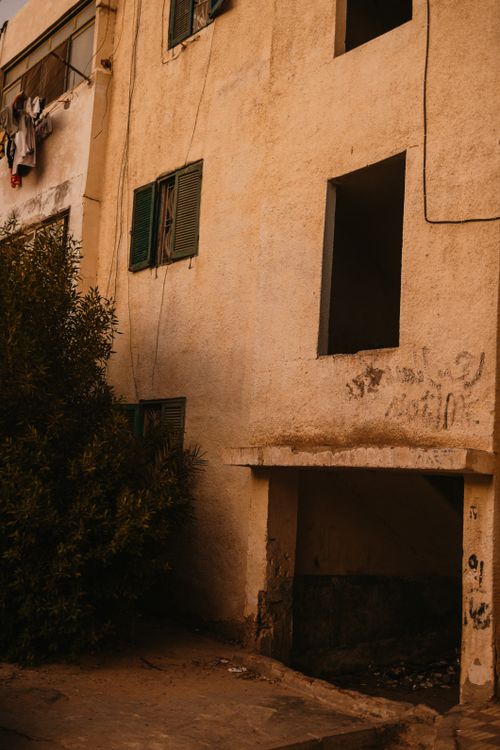 Free Abandoned Egyptian building with green shutters, showcasing architectural decay and urban atmosphere. Stock Photo