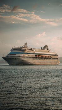 A serene view of a cruise ship sailing at sunset off the coast of Sinop, Turkey.