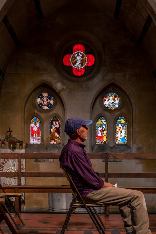 An Elderly Man Praying inside the Church