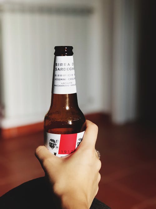 Hand Holding Empty Beer Bottle