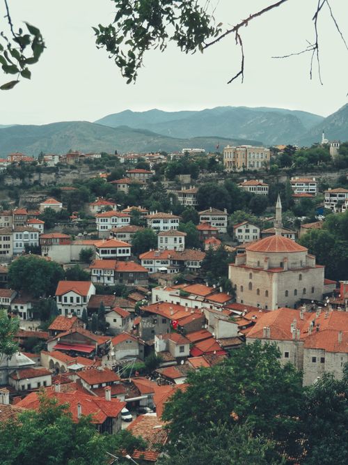 Free Aerial view of the Ottoman-style Ibrahim Pasha Mosque amid a historic town with red-tiled roofs. Stock Photo