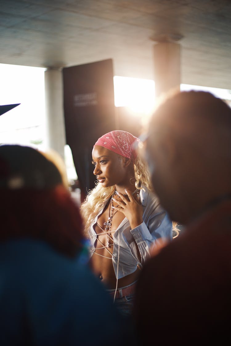 Woman Wearing Red Bandana Standing Behind People