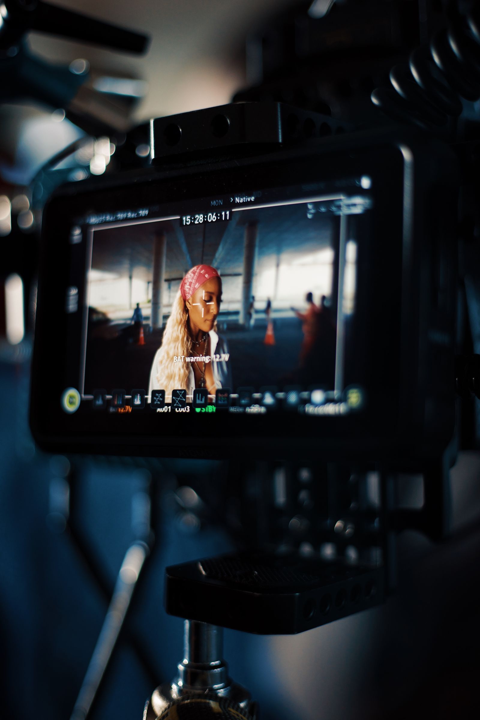 Camera monitor showing a performer during a polished production take