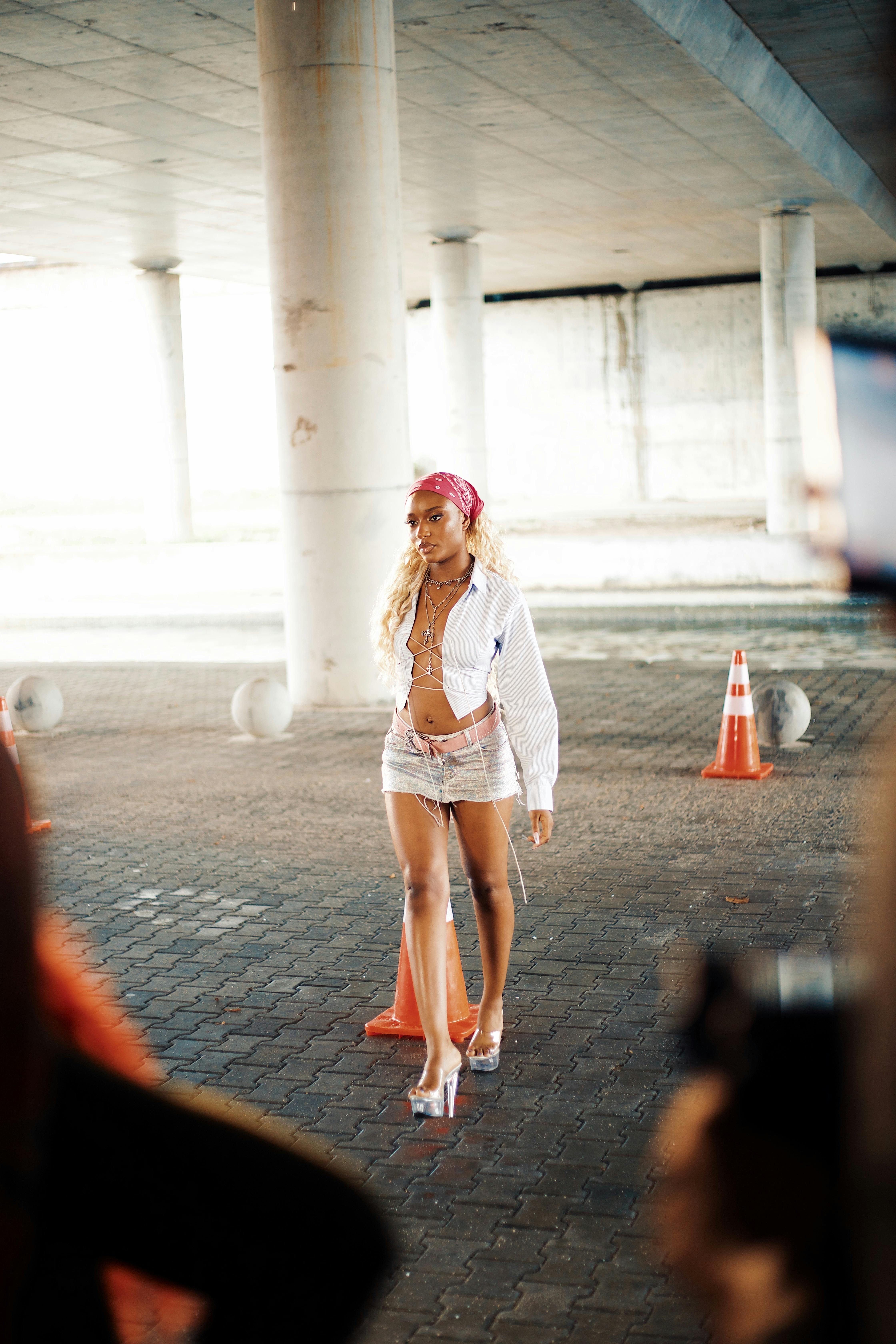 a woman in white long sleeve crop top walking on the street