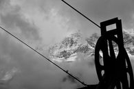 Grayscale Photography of Pulley Near Mountain