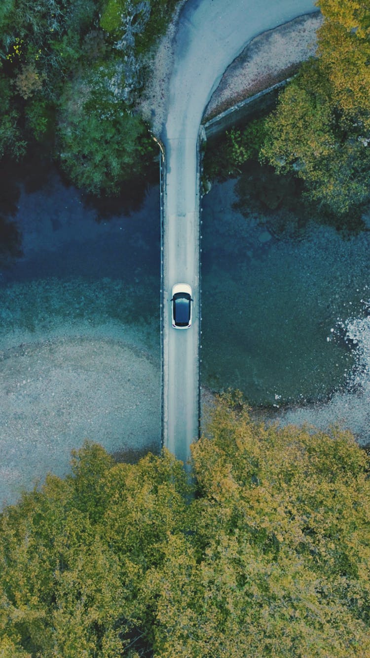 Aerial Photography Of A Car Driving On The Bridge