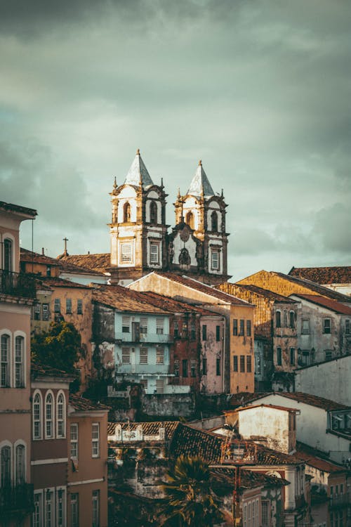 Old Cathedral Towers and Buildings Rooftops on Sky Background