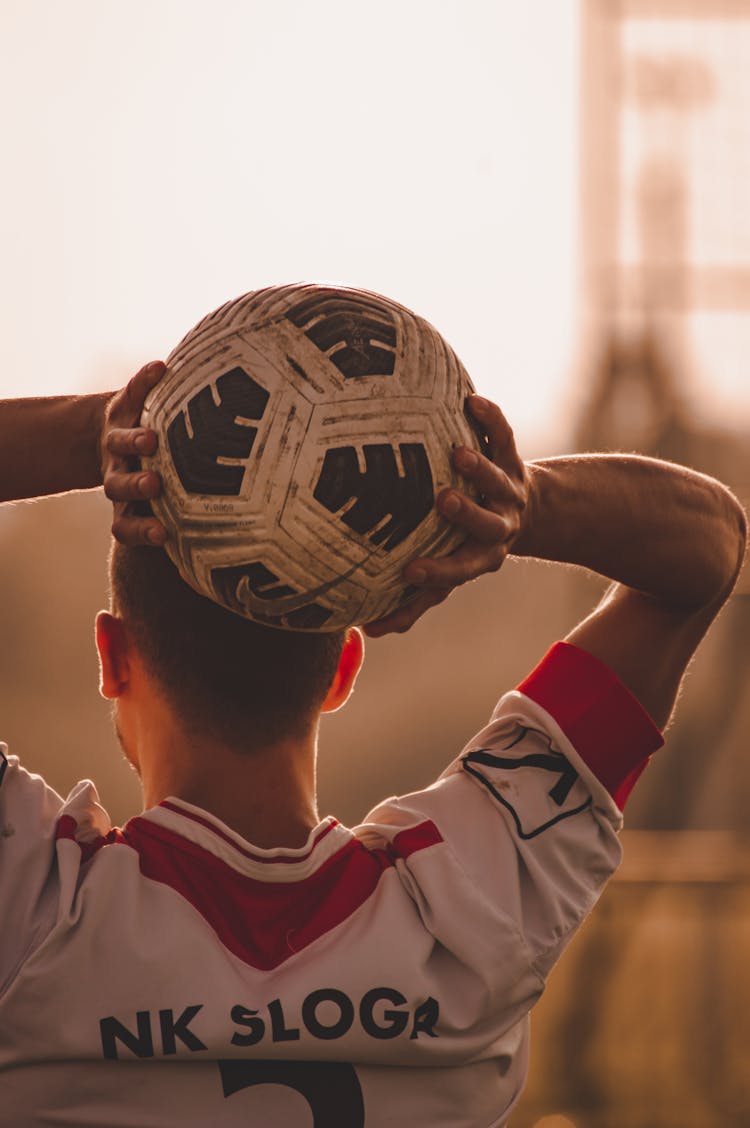 A Man Holding A Soccer Ball