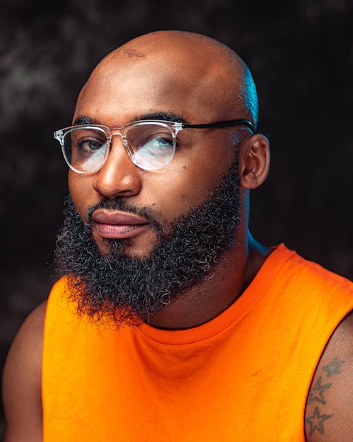 Bearded Man in Orange Tank Top Looking Sideways