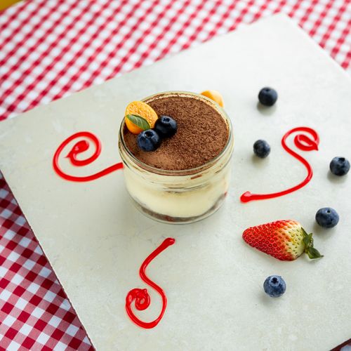 Free A delectable tiramisu dessert served in a jar with fresh berries and a chocolate topping. Stock Photo