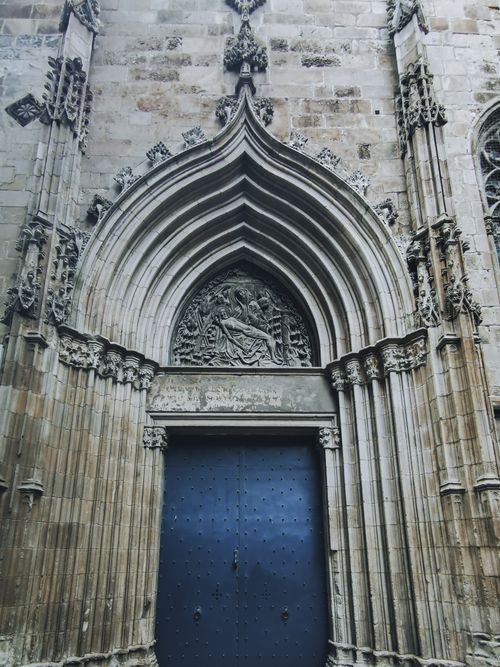 Free Explore the intricate Gothic architecture of a historic cathedral's entrance featuring detailed bas relief. Stock Photo