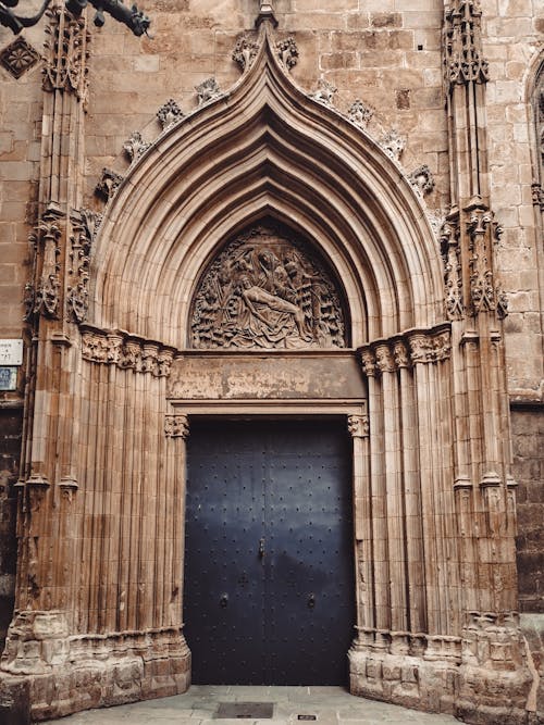 Black Metal Door on Brown Concrete Wall