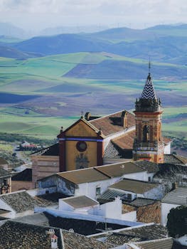 Aerial view of a historic church and vibrant landscape in the Spanish countryside.