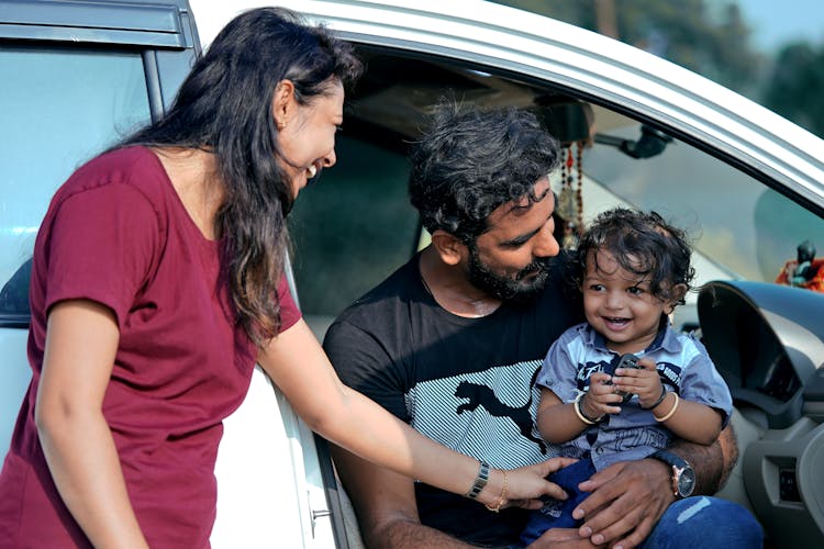 Smiling Mother With Father And Daughter In Car