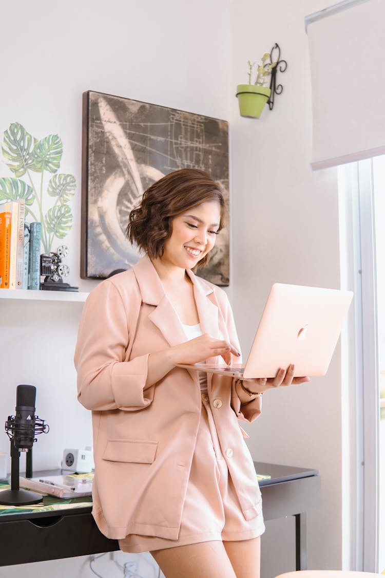 Woman In Coat With Laptop In Room