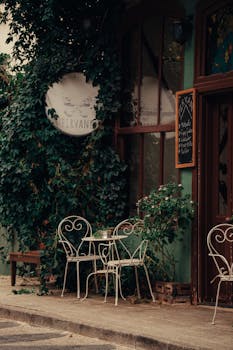 Picturesque outdoor café setting with vintage charm and iron chairs, perfect for a quaint dining experience.