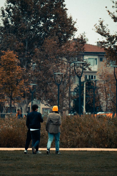 Woman and Man Walking in Park