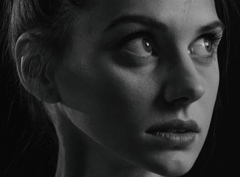 Close-up black and white portrait of a thoughtful woman in Kyiv, Ukraine.