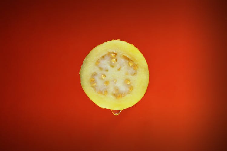 Sliced Guava Fruit On Red Surface