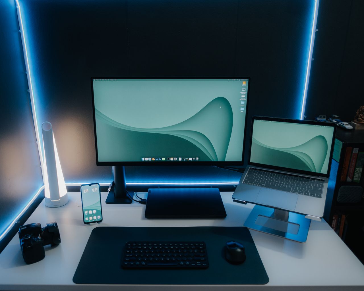 a sleek and modern desk setup featuring a monitor laptop and ambient l