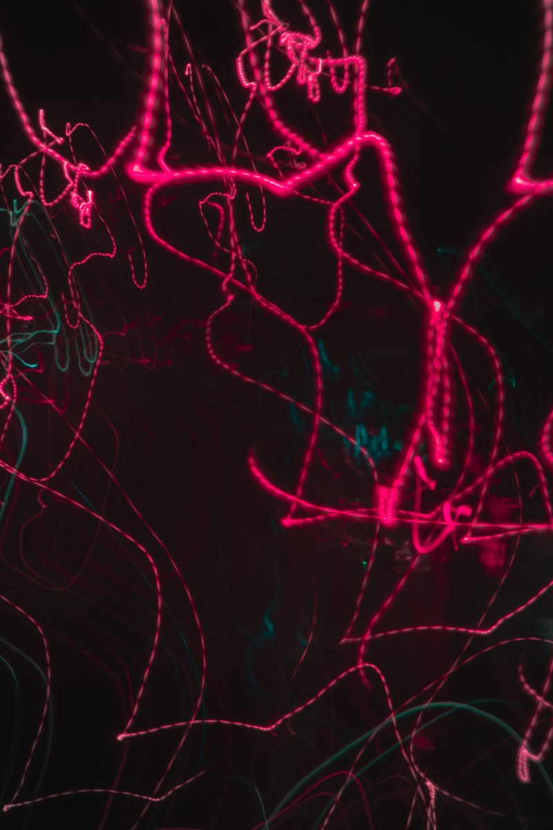 Dynamic neon light trails creating an abstract and energetic visual effect.