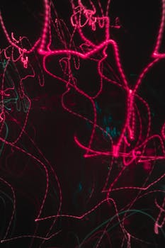 Dynamic neon light trails creating an abstract and energetic visual effect.