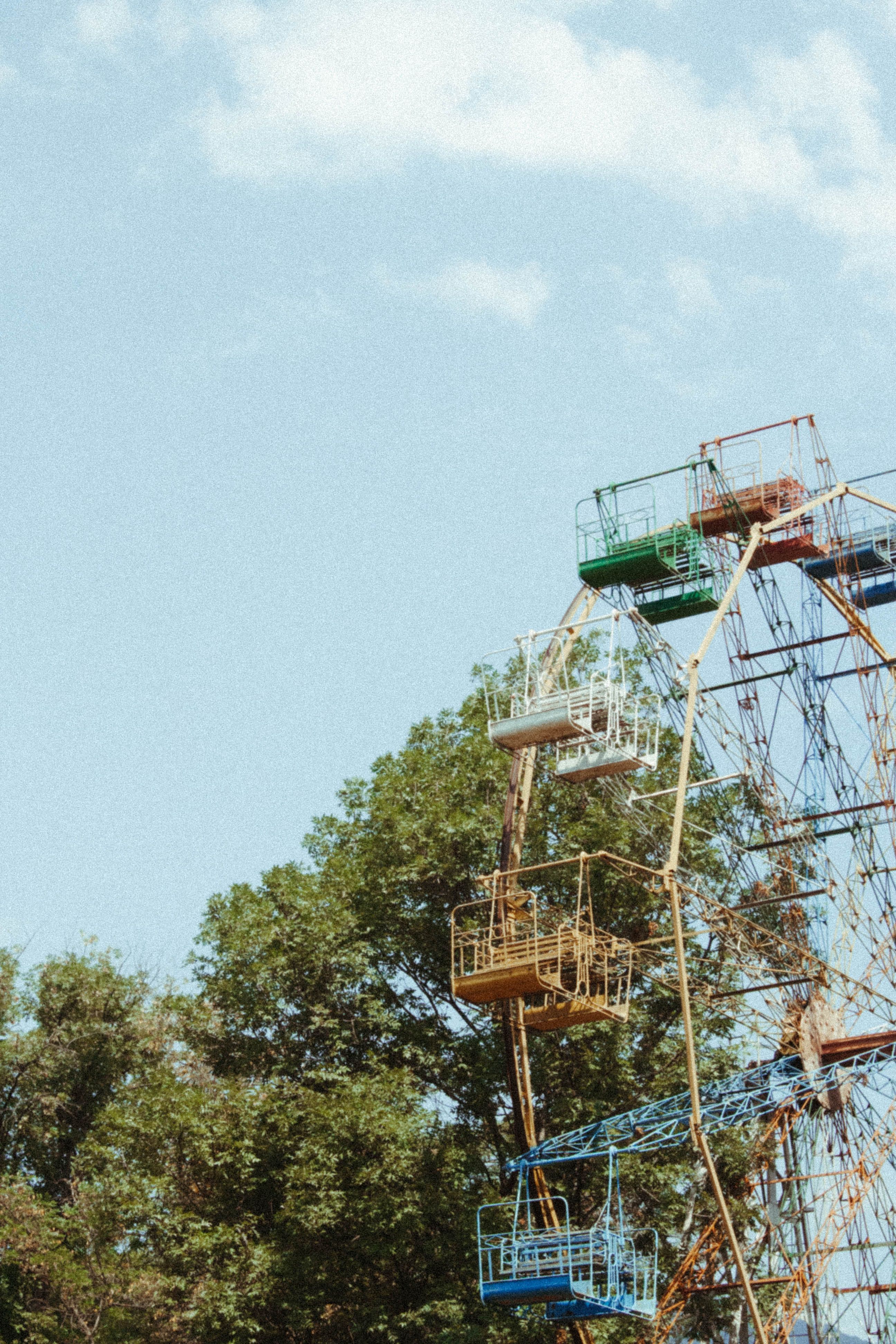 Blue Sky and Clouds above a Ferris Wheel · Free Stock Photo