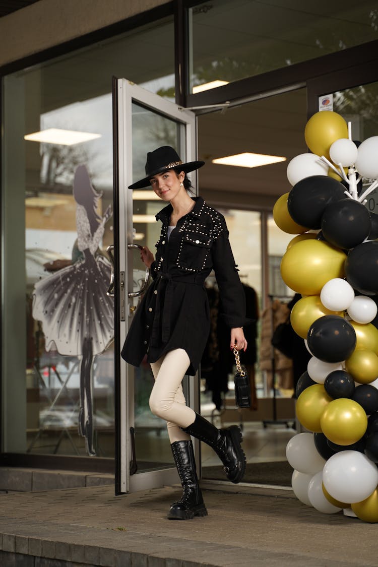 Fashionable Woman Walking Out Of A Clothing Store 