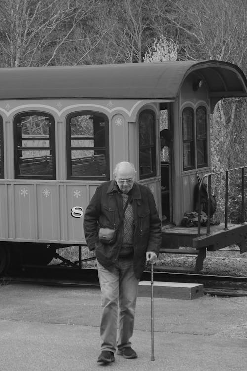 An Elderly Man Walking with Cane