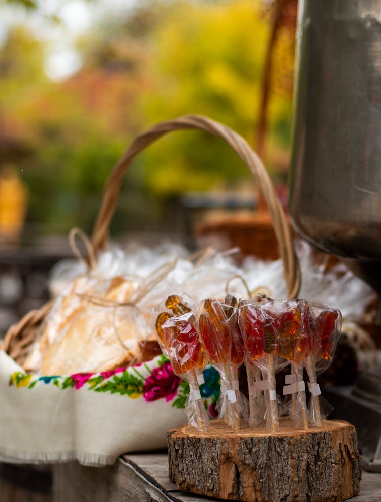 Sugar Lollipops On Wood Log Selling On Market