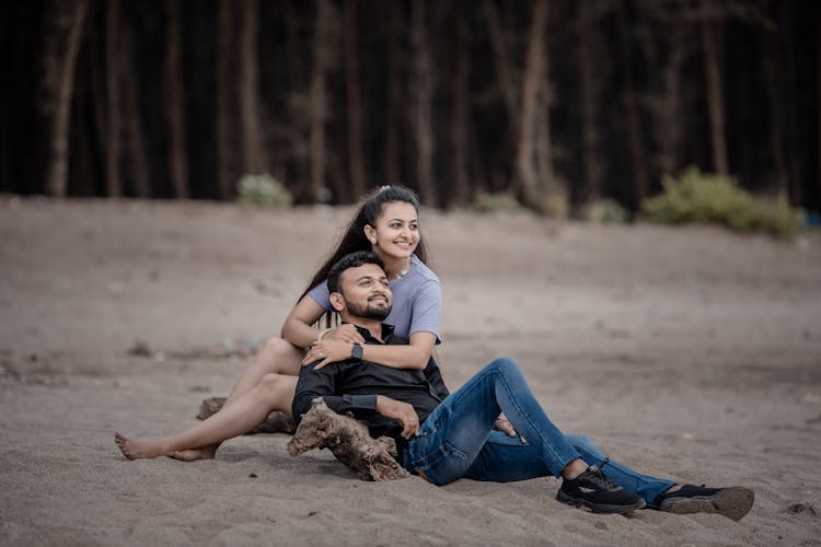 Couple Hugging Lying On Sand Beach