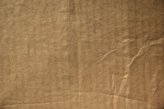 A close-up of crumpled brown cardboard texture, ideal for creative projects and backgrounds.