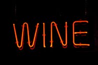 特写：黑暗背景上，红色霓虹灯葡萄酒标志被照亮