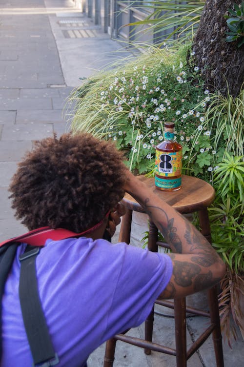 Man photographing a liquor bottle