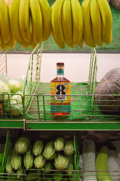 Fruit shelf displaying a liquor bottle