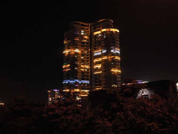 Illuminated office towers at night — free dating site in Gurgaon corporate skyline