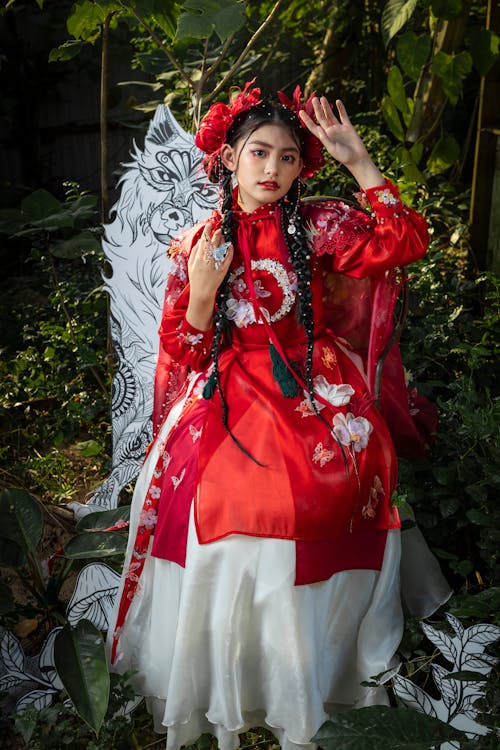 A Beautiful Young Girl Wearing Red Hanfu Dress Posing at the Camera