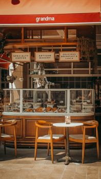 Warm and inviting artisan bakery with wooden seating and pastry display.