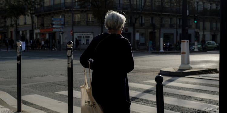 Elderly Person On Pedestrian Crossing In City