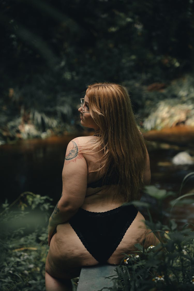 Woman In Black Bikini Sitting