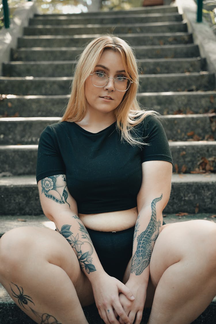 Blonde Woman Sitting On Stairs