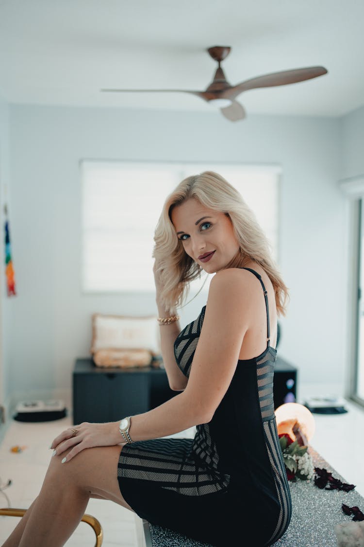 Blonde Woman Sitting In Room