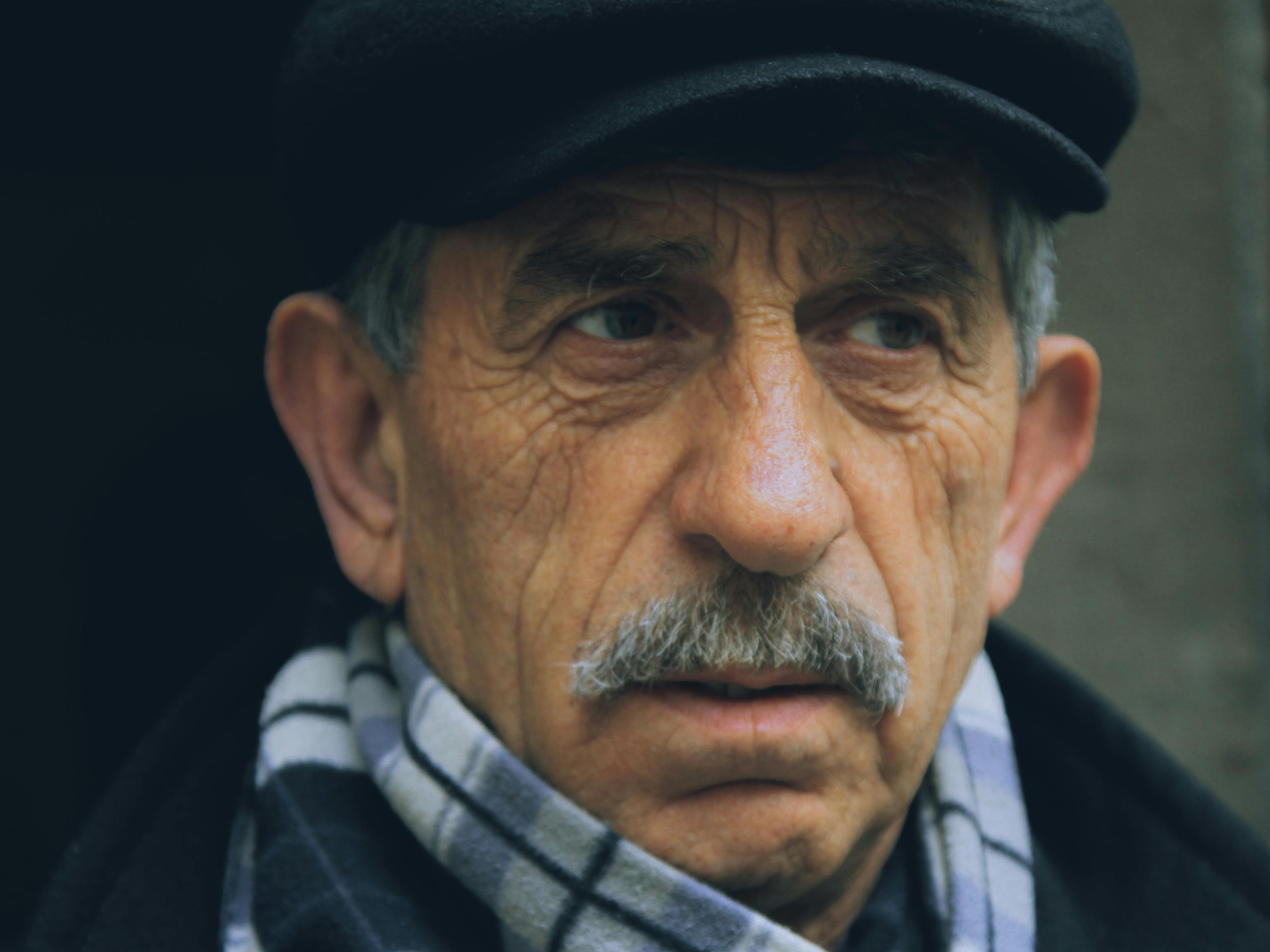 man in black and white striped scarf wearing black hat